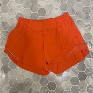 Orange Lululemon shorts 4”